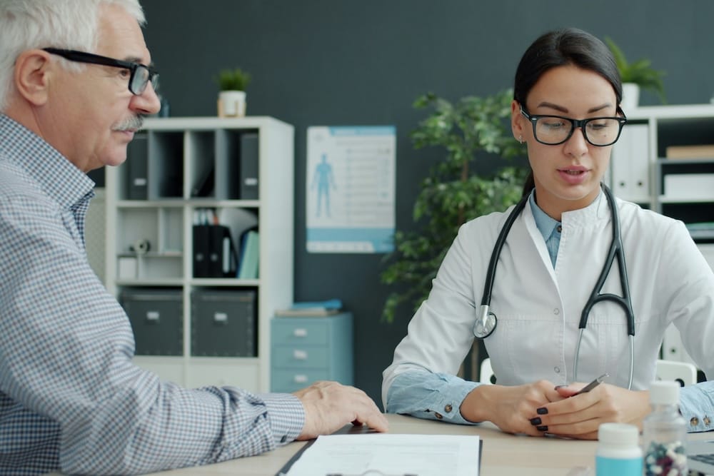 Image of a man sitting with his doctor.