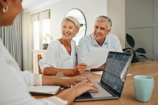 Photo of senior couple planning great wealth transfer with advisor