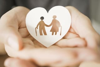 Picture of a paper heart with a drawing of a senior couple with canes