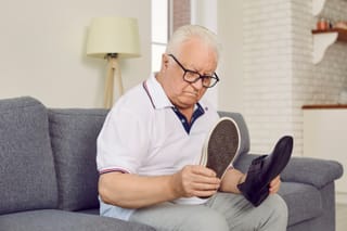 Image of a senior man evaluating shoes