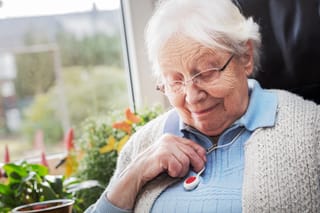 Picture of a senior woman with a medical alert button 