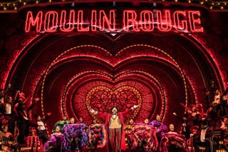 Image of the Moulin Rouge Musical stage and set with many actors