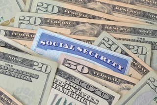 Picture of a social security card with 20 dollar bills, 50 dollar bills, and 100 bills 