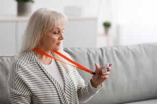 Picture of a senior woman with a Bay Alarm Medical emergency button and lanyard 