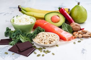 Picture of brain foods including salmon, dark chocolate, avocado, and nuts