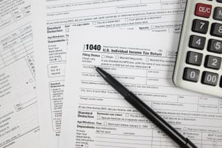 Picture of a US federal tax return, pen, and calculator 