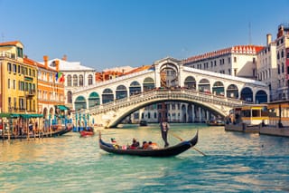 Picture of a gondola on the water near the Rialto Bridge in Venice Italy