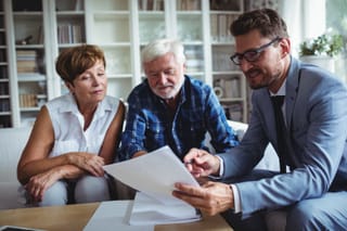 Picture of a senior couple reviewing information with a financial advisor