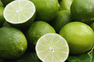 Image of several whole limes and one cut in half