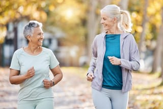 Image of two senior women walking together outside