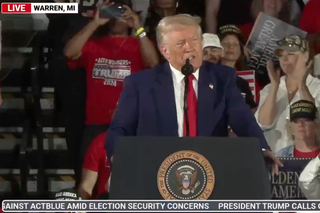 Photo of Trump speaking at his first 100 day rally
