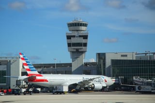 Picture of an air traffic control tower and airplane at Miami airport