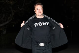 Photo of Elon Musk wearing a DOGE shirt 