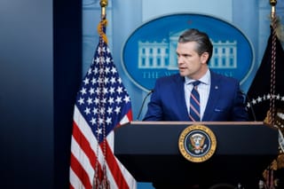 Photo of Secretary Pete Hegseth speaking at a lecturn 