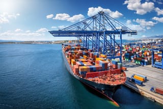 Picture of a container ship being unloaded at a port
