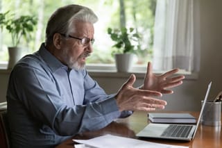 Picture of an upset senior man looking at his computer