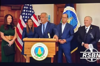 Photo of Secretary Kennedy and Secretary Rollins at a press conference 