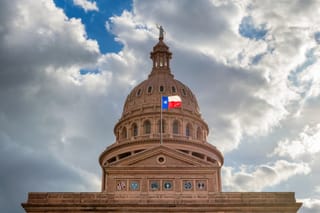 Picture of the Texas State Capitol building and Texas flag
