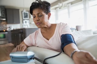 Picture of a senior woman checking her blood pressure at home 