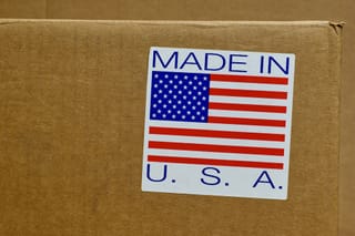 Picture of a shipping box with a sticker saying Made in USA along with a U.S. Flag