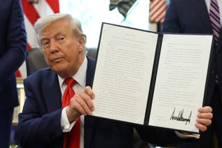 Picture of President Donald Trump in the Oval Office after signing an executive order 