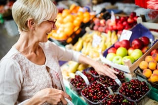 Image of older woman shopping for fruits