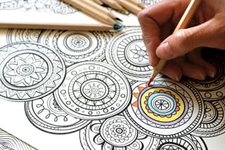 Image of a person using colored pencils.