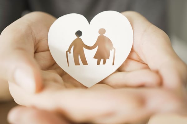 Picture of a paper heart with a drawing of a senior couple with canes