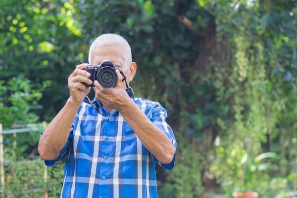 Picture of a senior man with a digital camera