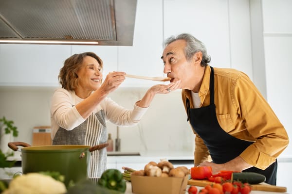 Image of a senior couple making fresh vegetable soup