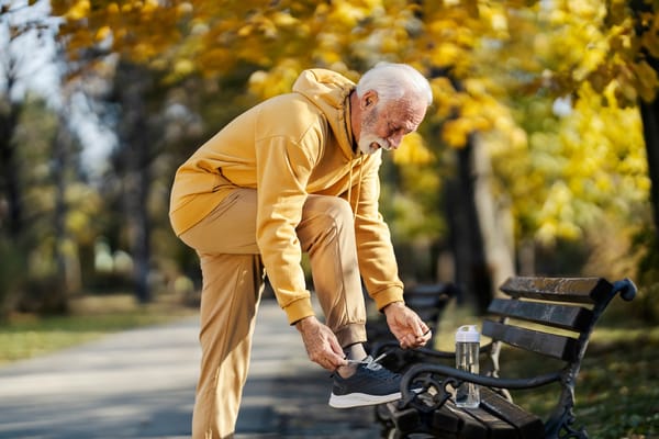 Image of a senior man adjusting his athletic shoes