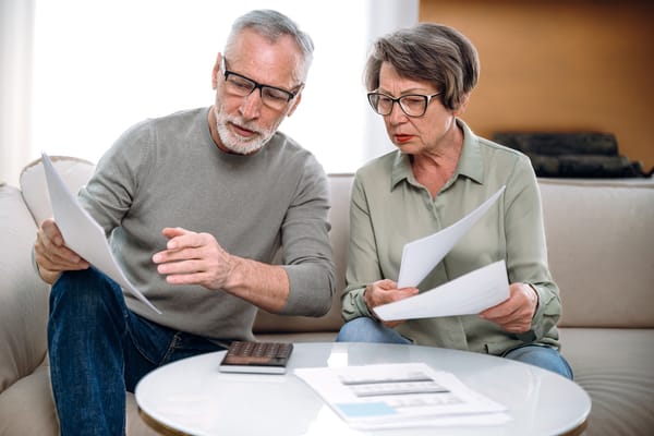 Image of a mature couple reading their credit report