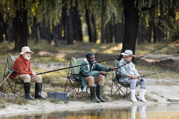 Image of 3 seniors fishing on a lake from the shore