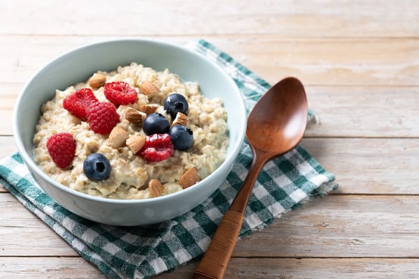 Image of a bowl of steel cut oatmeal with blueberries, raspberries, and nuts