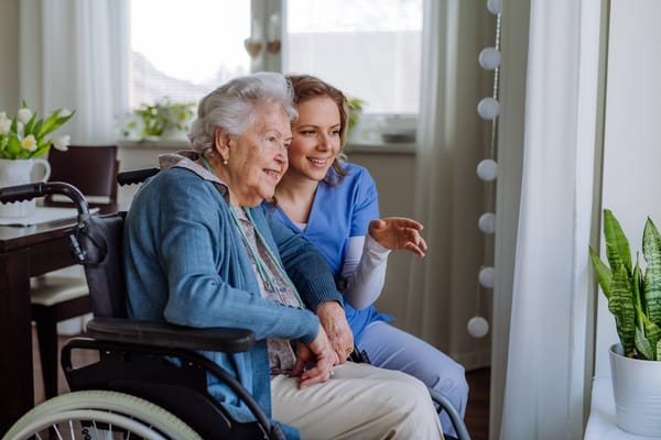 Picture of a senior woman in a wheelchair with a home care professional