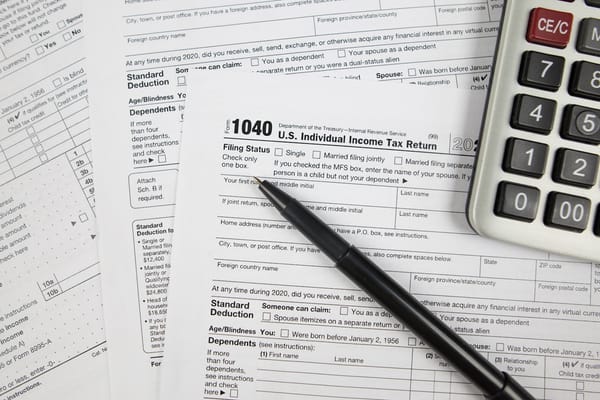 Picture of a US federal tax return, pen, and calculator 