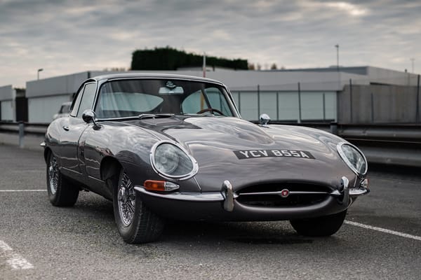 Picture of a silver Jaguar E-Type coupe