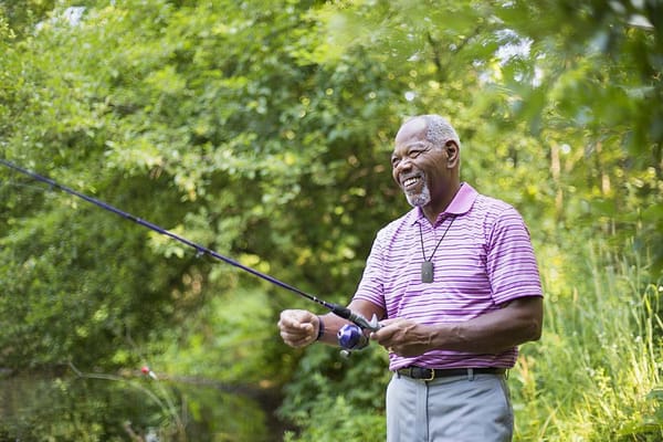 Picture of a man fishing with a portable Philips Lifeline medical alert system