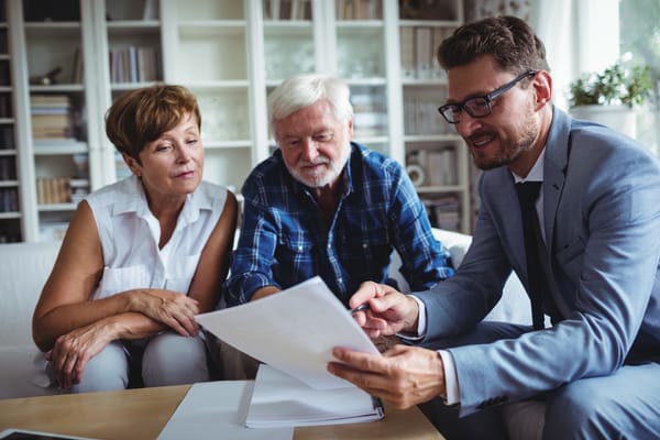 Picture of a senior couple reviewing information with a financial advisor