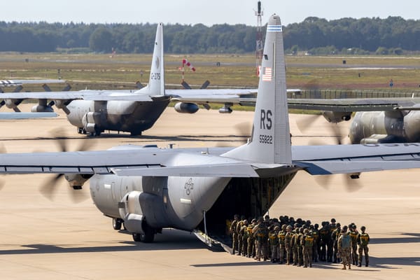 Picture of US military planes being boarded by military personnel 