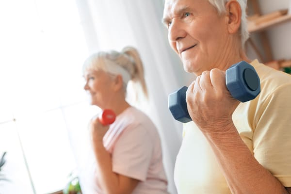 Image of older couple lifting arm weights