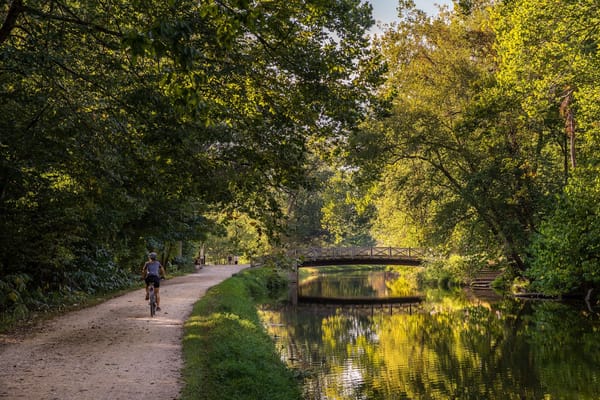 Image of a person riding a bicycle along the Chesapeake & Ohio Canal