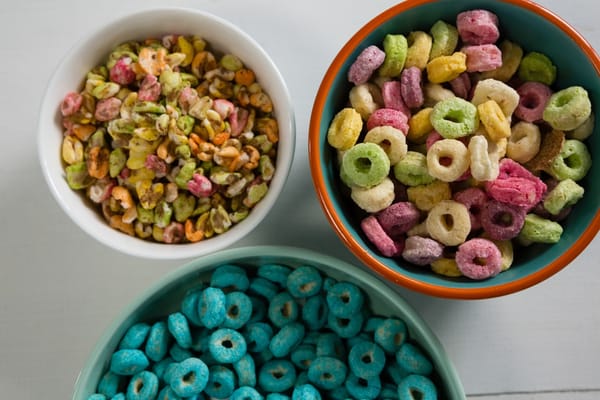 Image of three bowls of brightly colored cereals