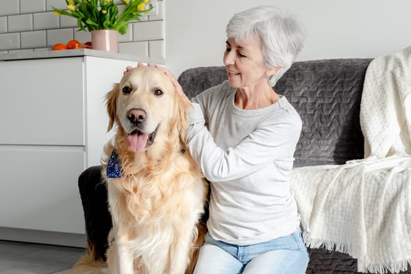 Picture of a senior woman with a golden retriever