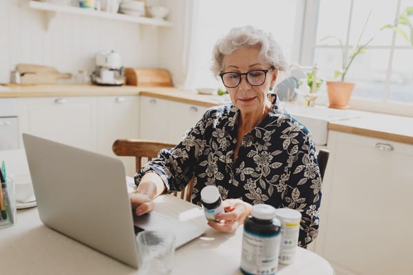 Image of senior woman reading supplement labels