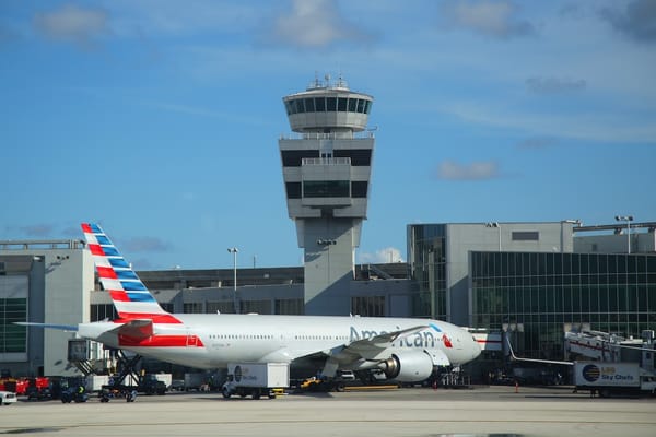 Picture of an air traffic control tower and airplane at Miami airport