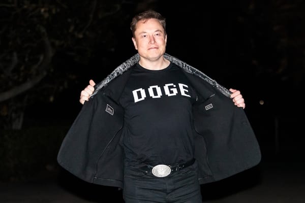 Photo of Elon Musk wearing a DOGE shirt 