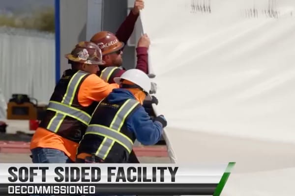 Picture of workers taking down an illegal immigrant center in San Diego 
