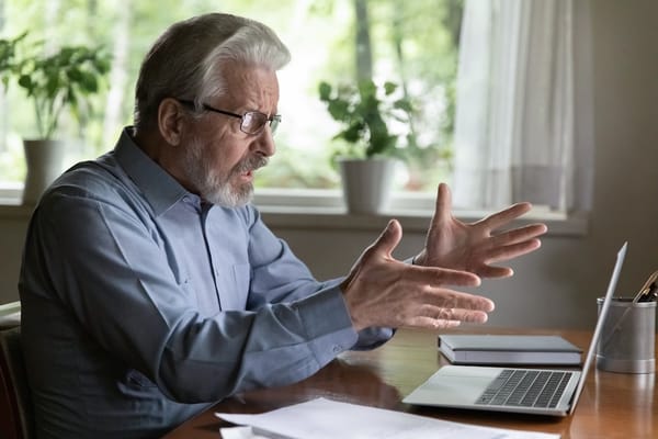 Picture of an upset senior man looking at his computer