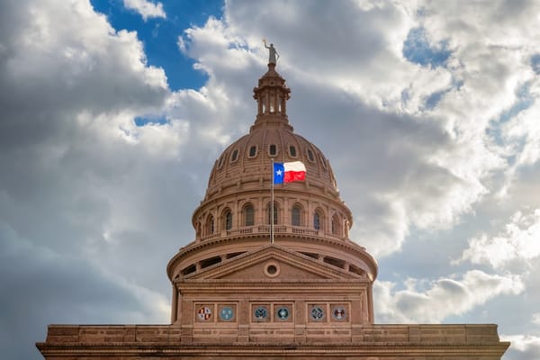 Picture of the Texas State Capitol building and Texas flag